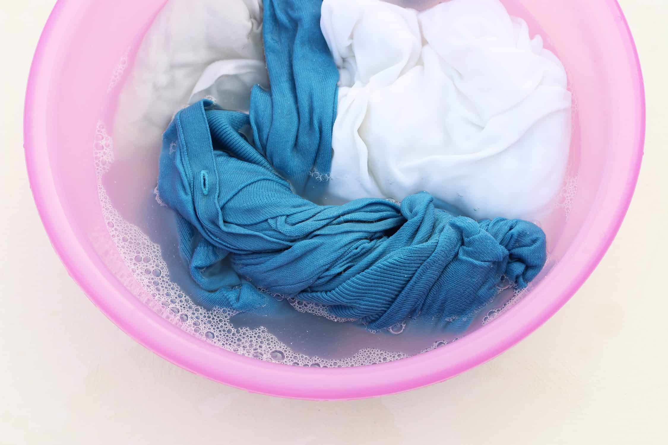 scrubs soaking in cold water to remove stains